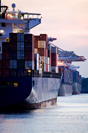 container cargo ships docked in port - three freighters sunset